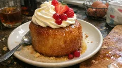 Grandma-style baba au rhum with vanilla Chantilly and fresh berries